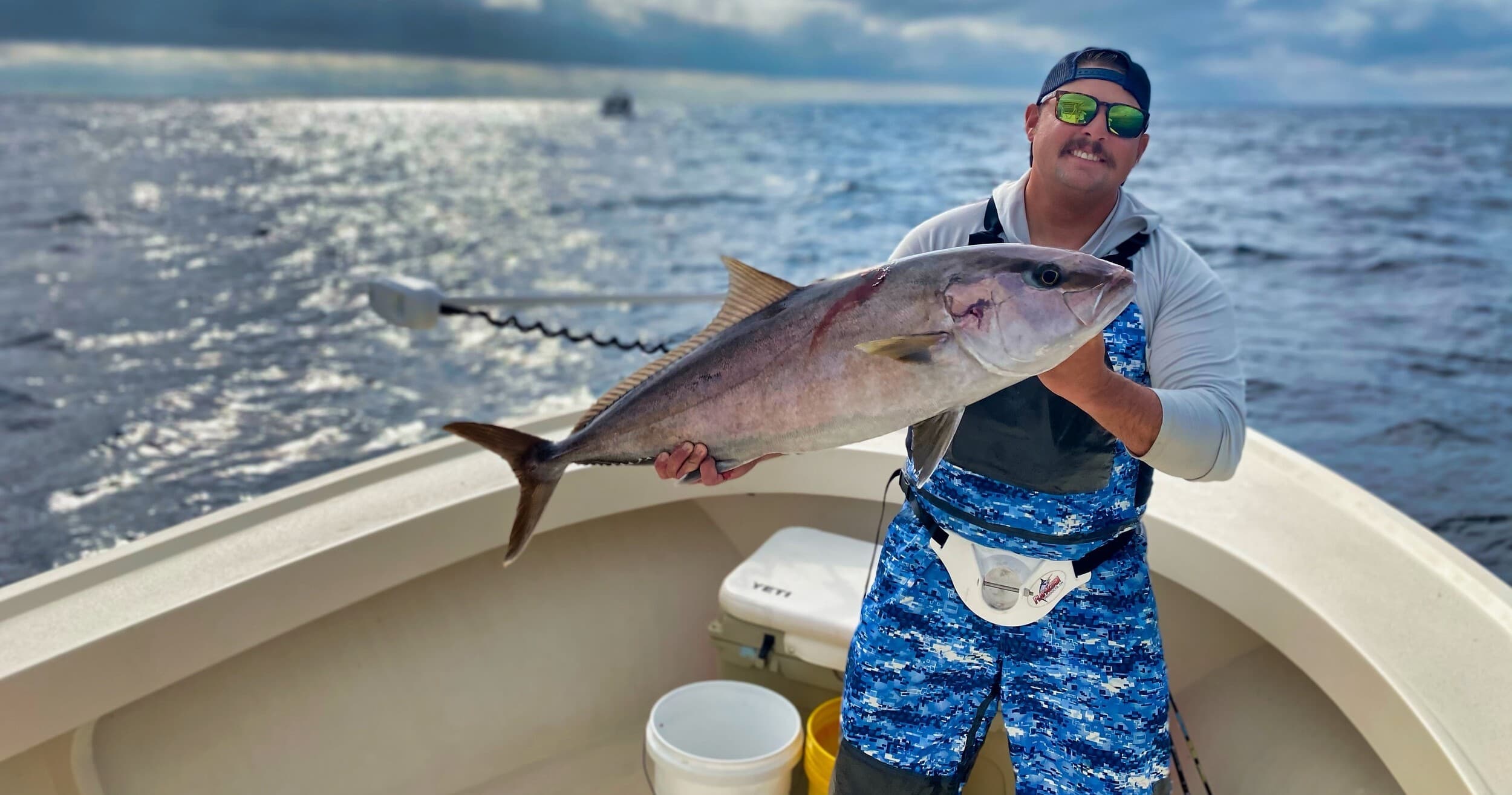 Angler holding large tuna on Destin Gulf deep-sea charter