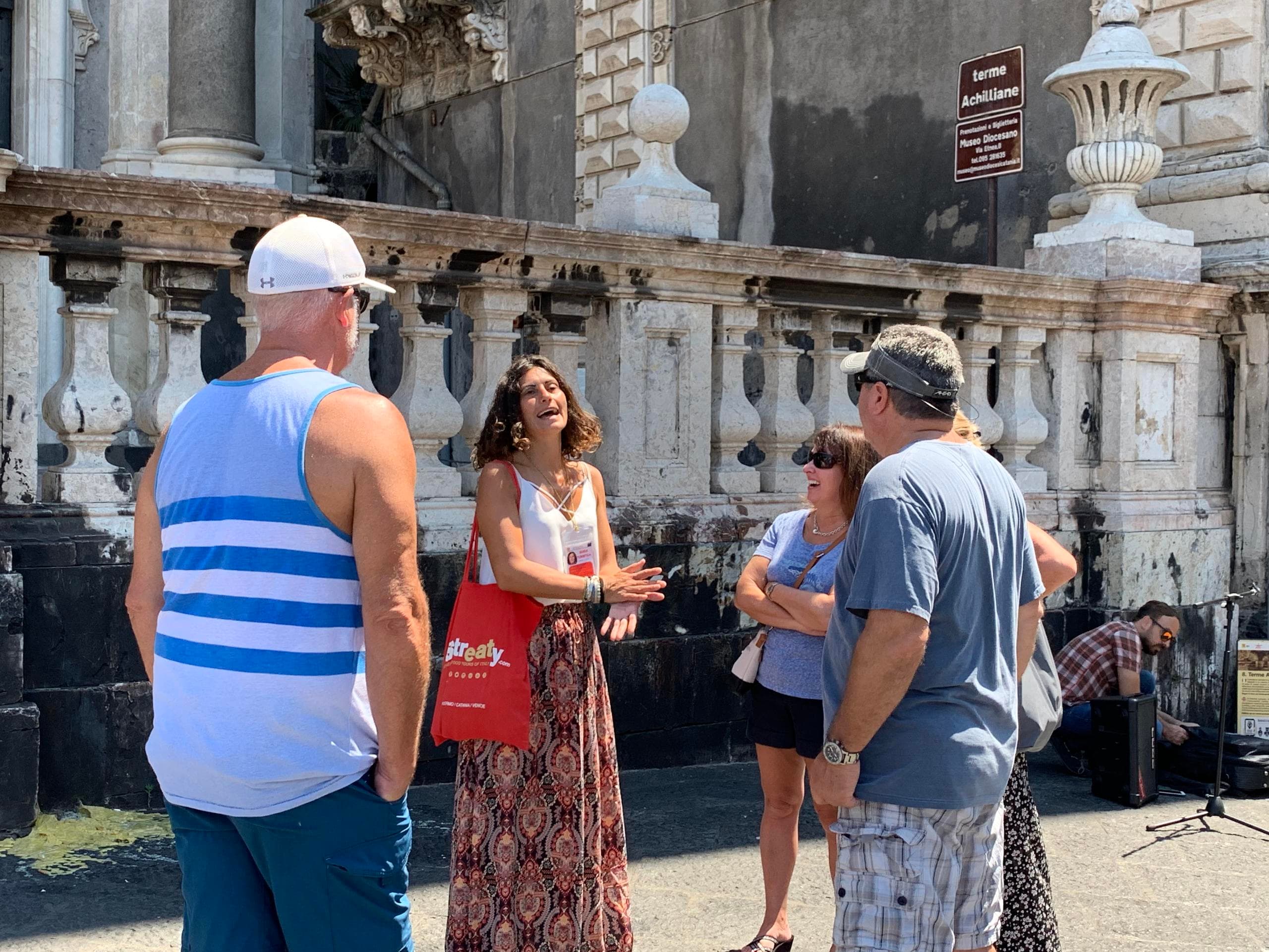 Small group on guided walking tour in historic piazza