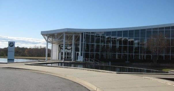 BMW US factory campus exterior with reflecting pond and entrance
