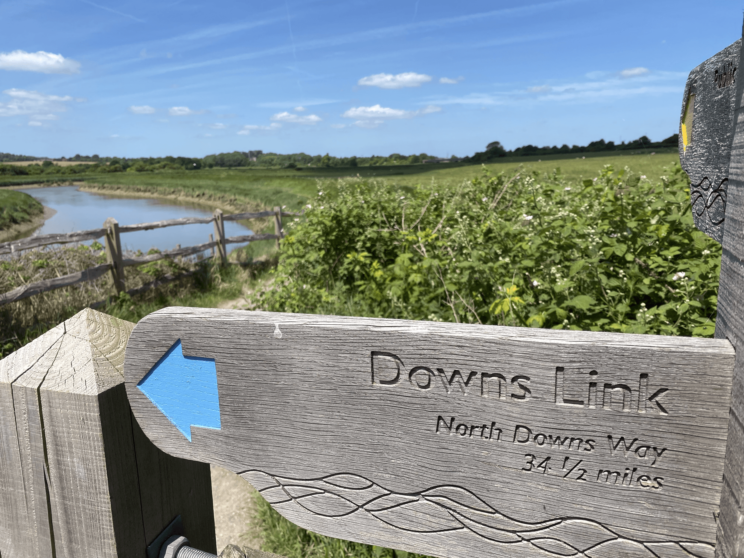 Trail sign for Downs Link on scenic riverside country trail