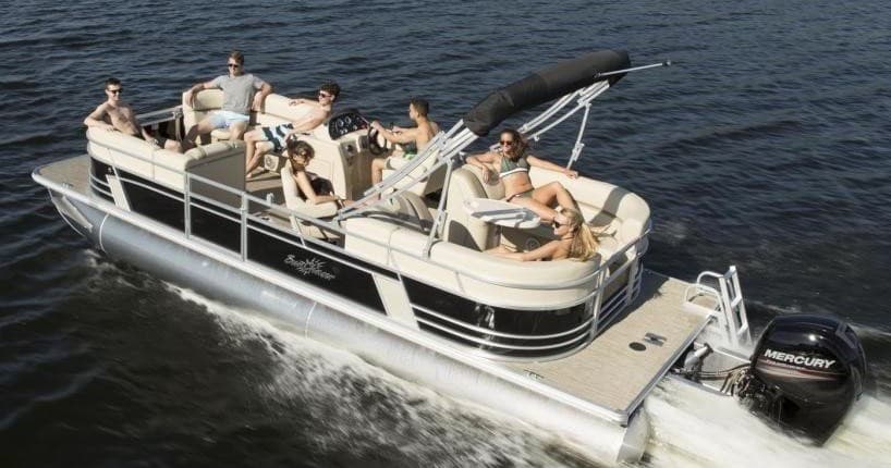 Group on pontoon boat cruising open water under sunny sky