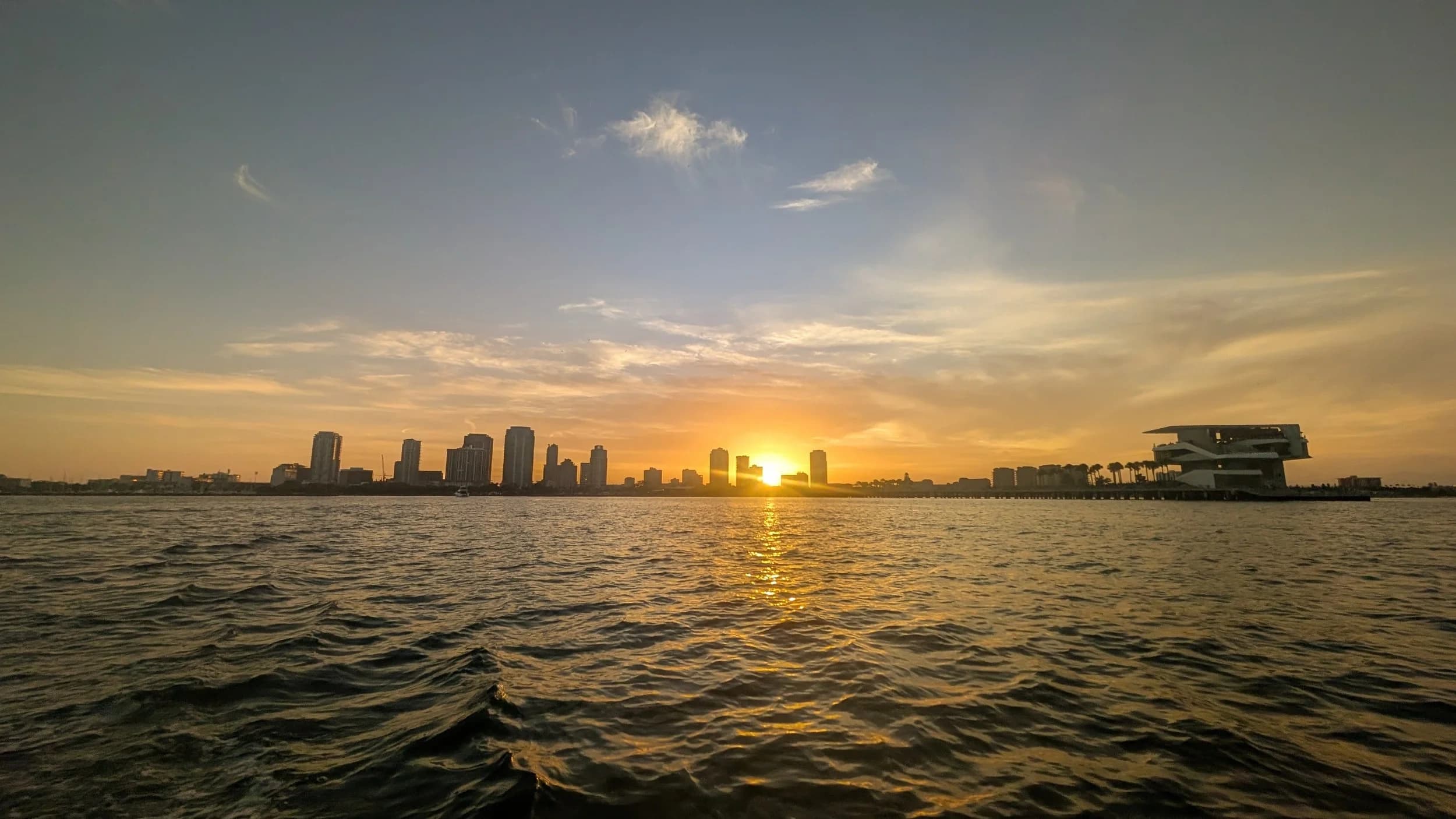 Sunset skyline viewed from sailboat on open water