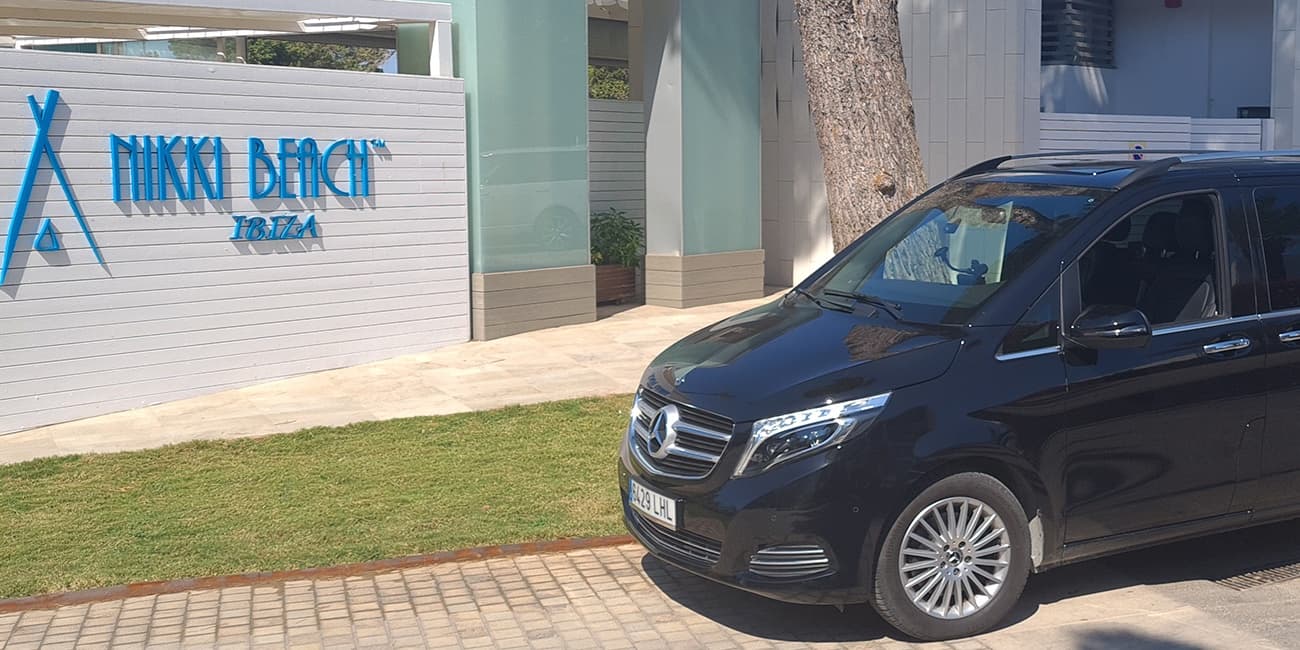 Luxury VIP transfer van outside Nikki Beach club entrance Ibiza