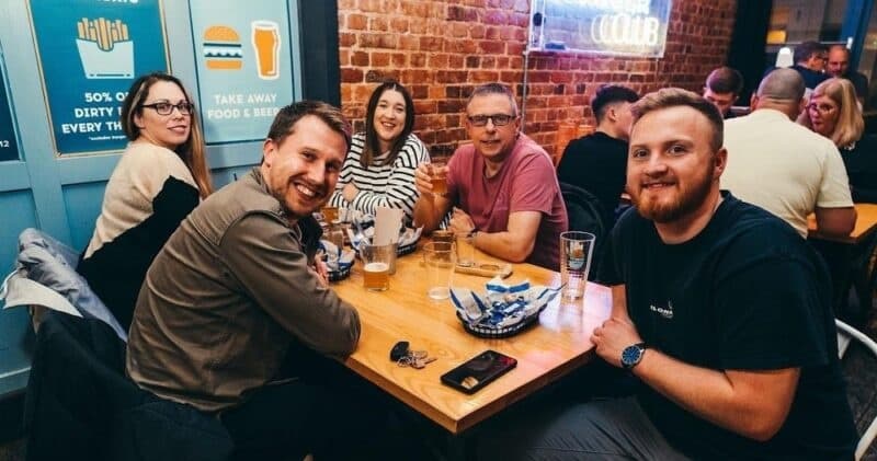 Friends dining and drinking at a busy Portsmouth gastropub table