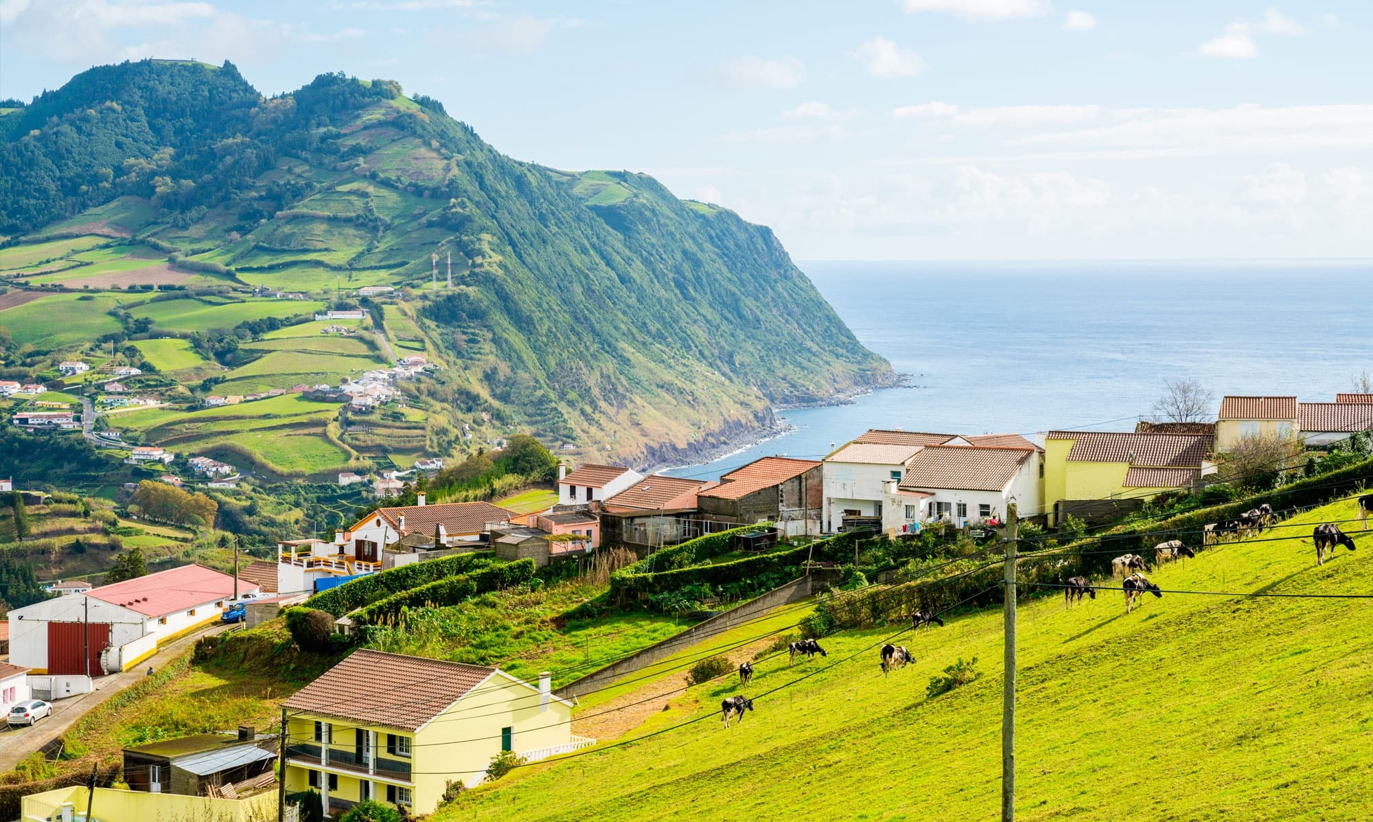 Coastal village and cliffs overlooking Atlantic Ocean in Azores