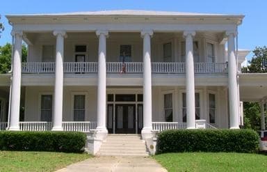 Antebellum mansion with columned porch on southern historic grounds