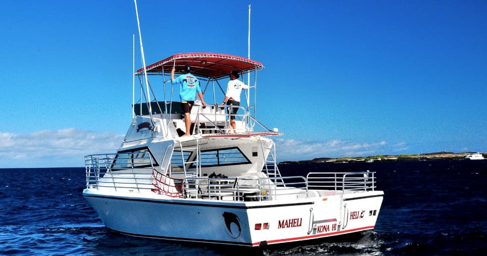 Charter boat on calm Kona waters for snorkeling and whale tours