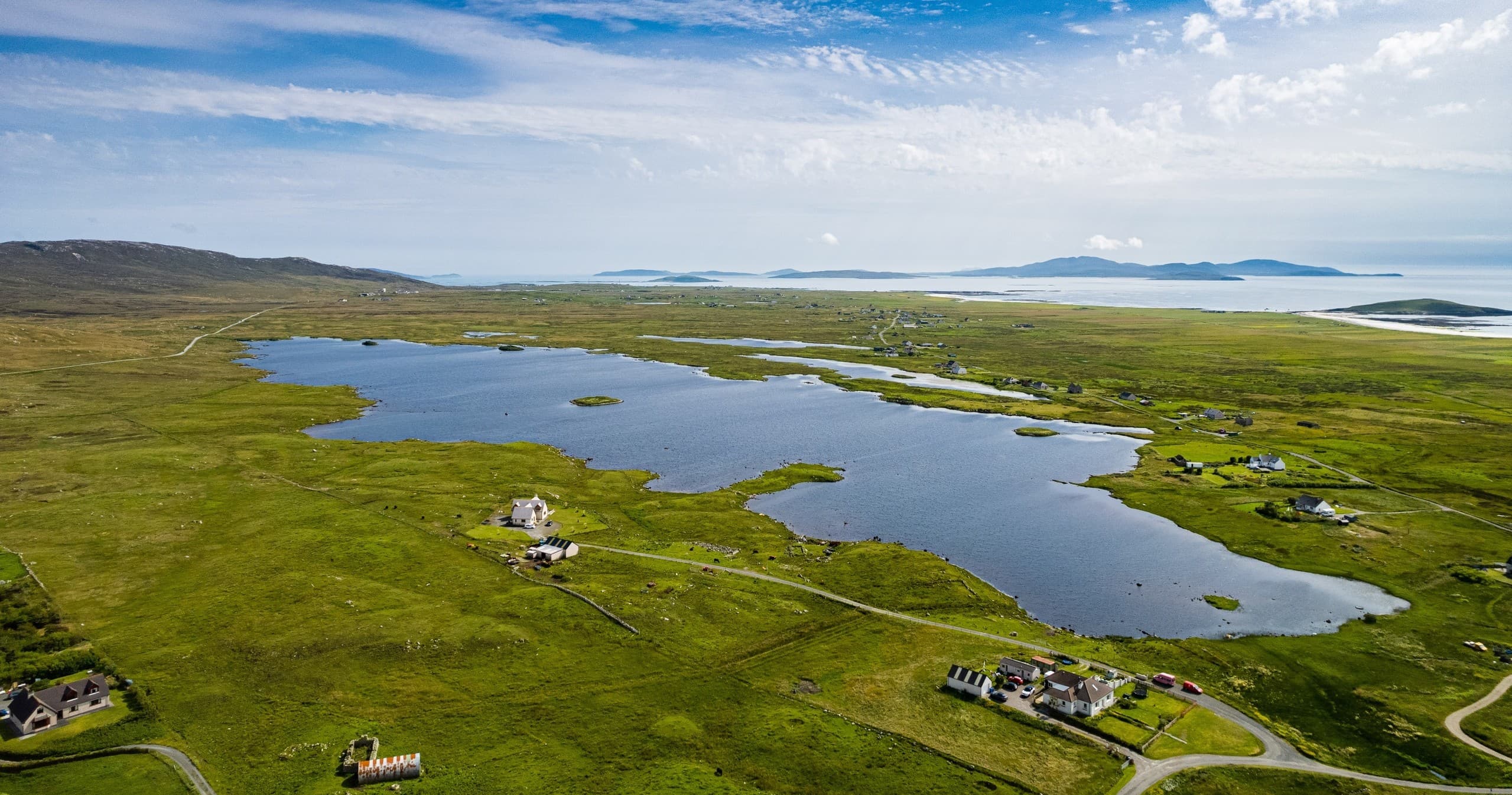 Aerial view of South Uist coastal loch and green fishing landscape