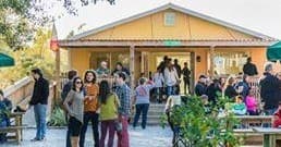 Crowd enjoying outdoor beer garden at neighborhood brewpub