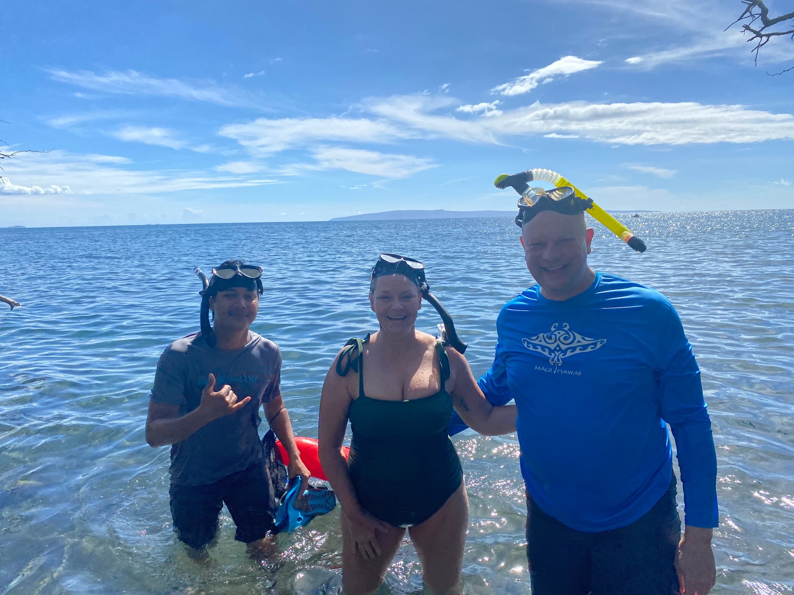 Snorkelers guided tour wading in clear Maui coastal waters
