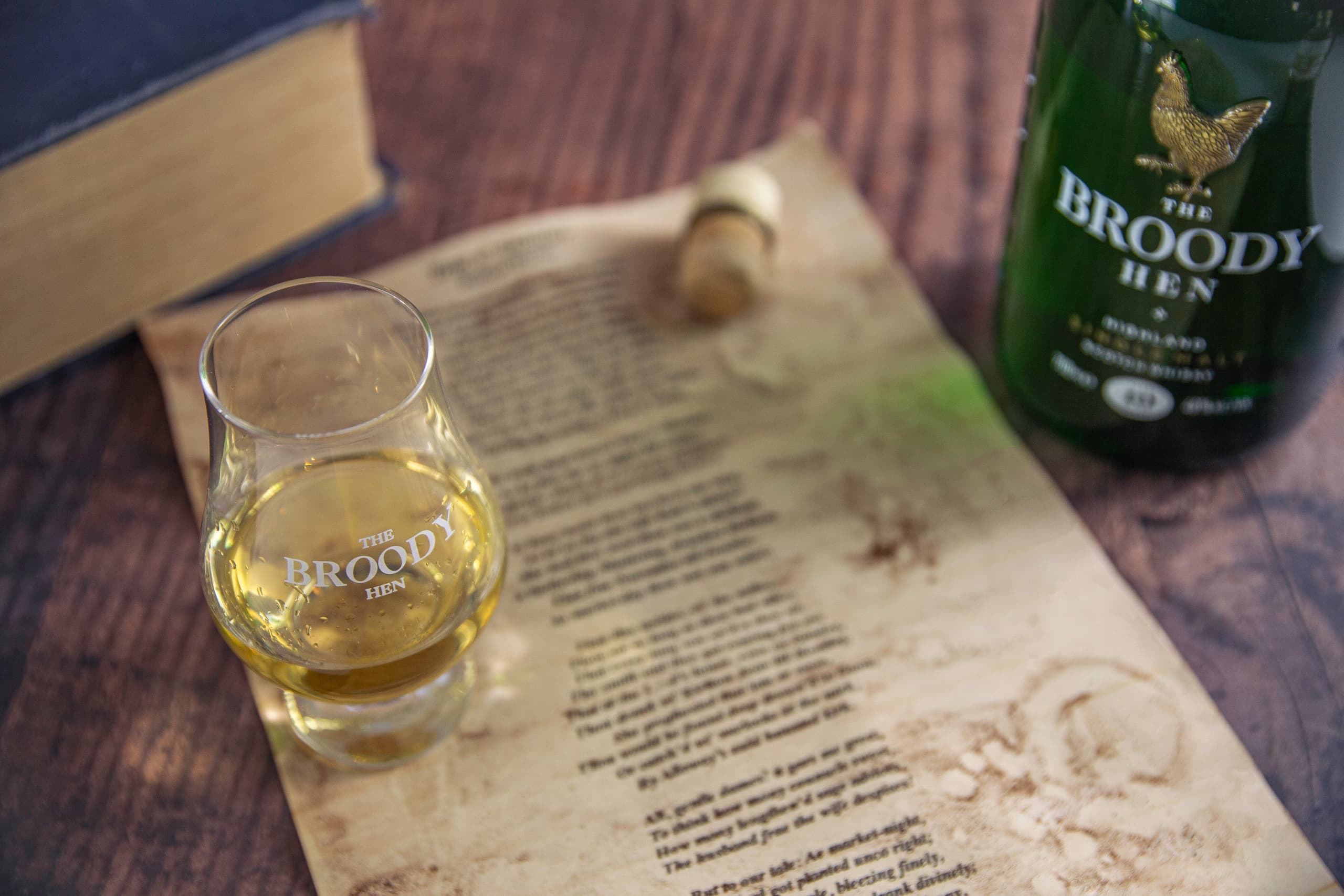 Single malt tasting glass with distillery menu on wooden table