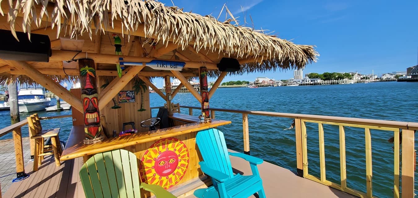 Daytime tiki deck with colorful chairs on coastal cruise