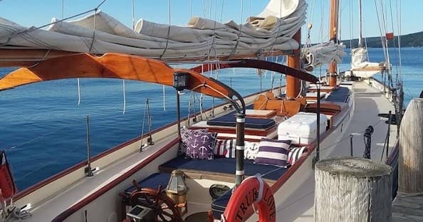Deck view of classic schooner interior with rigging and sea view