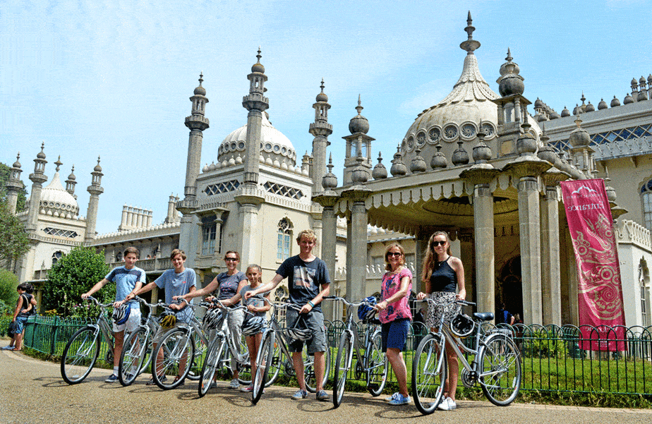 Cyclists posing with bikes at Brighton ornate seaside pavilion
