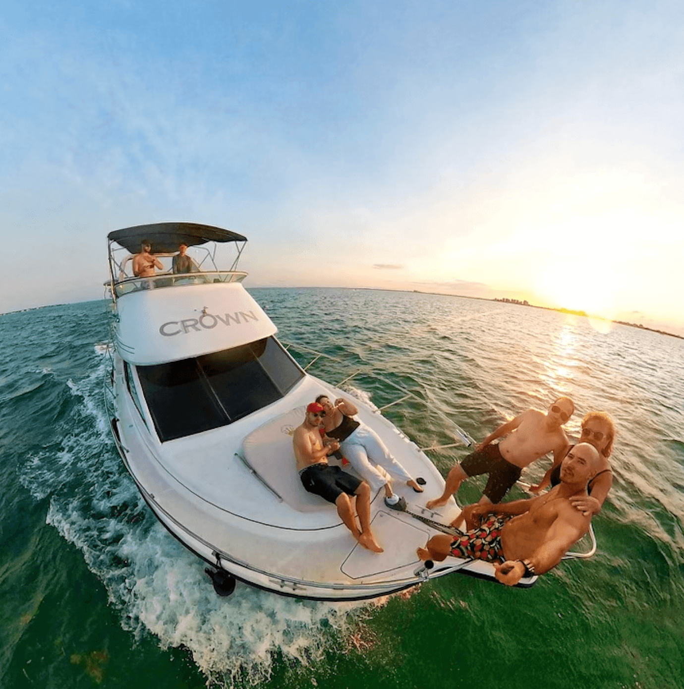 Sunset yacht cruising on open ocean with friends aboard