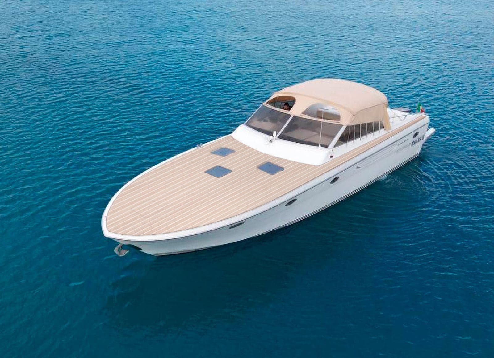 Luxury motorboat cruising on open ocean, private yacht charter