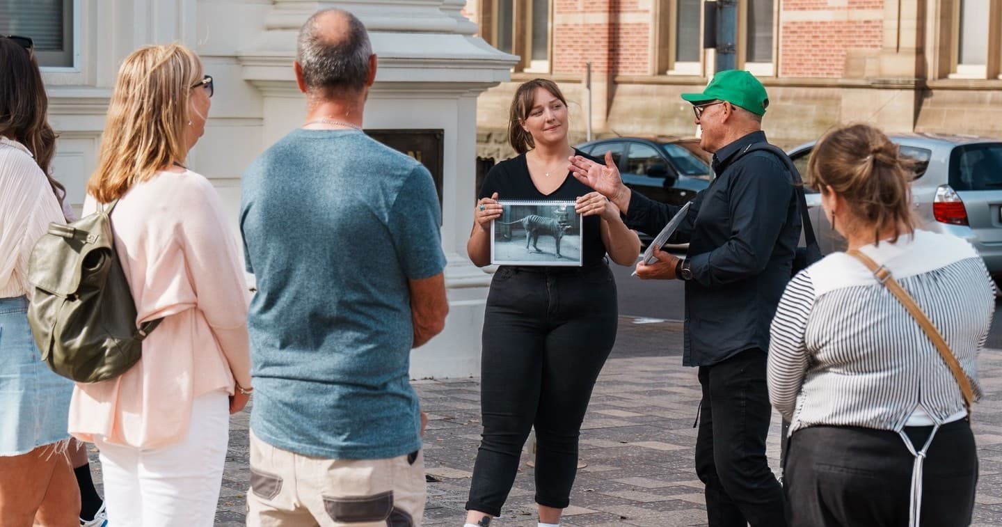 Guide leading outdoor walking tour through historic Launceston streets