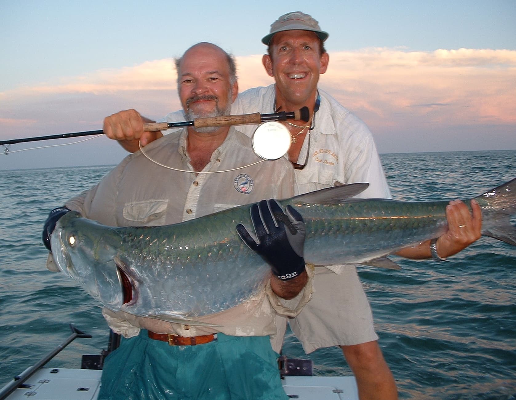 Two anglers with large tarpon at sunset off Key West