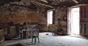 Rustic winery attic or cellar room interior with sunlit doorway