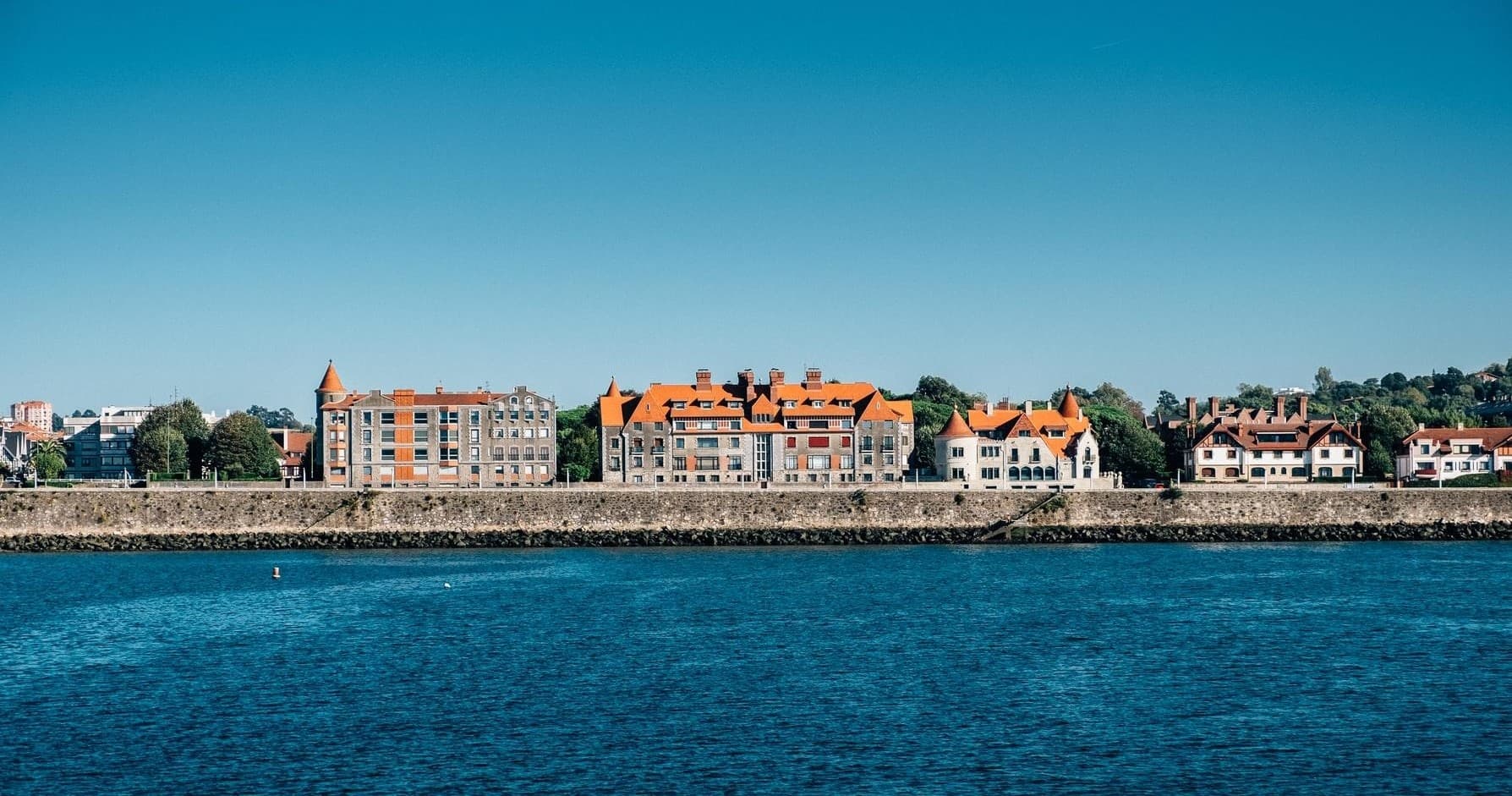 Panoramic seaside promenade in Bilbao lined with coastal buildings