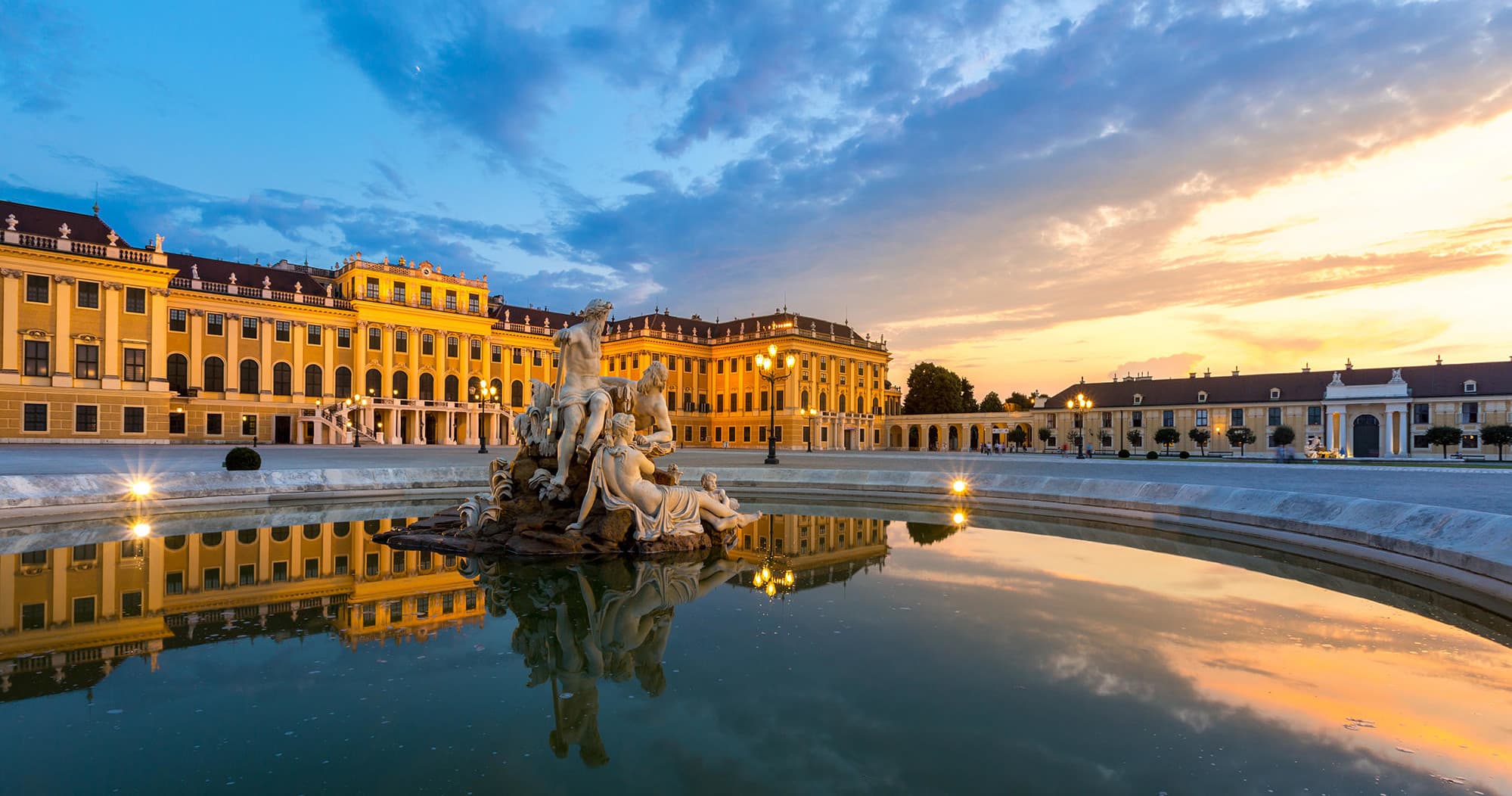 Sunset at Schönbrunn Palace fountain reflecting golden façade