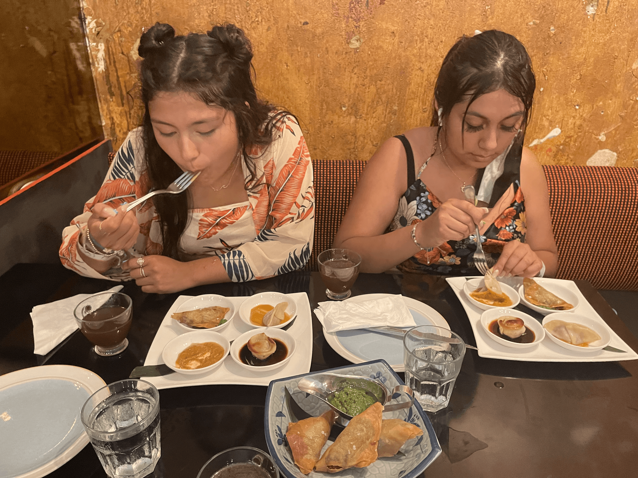 Friends enjoying dumpling tasting at indoor San Juan food tour