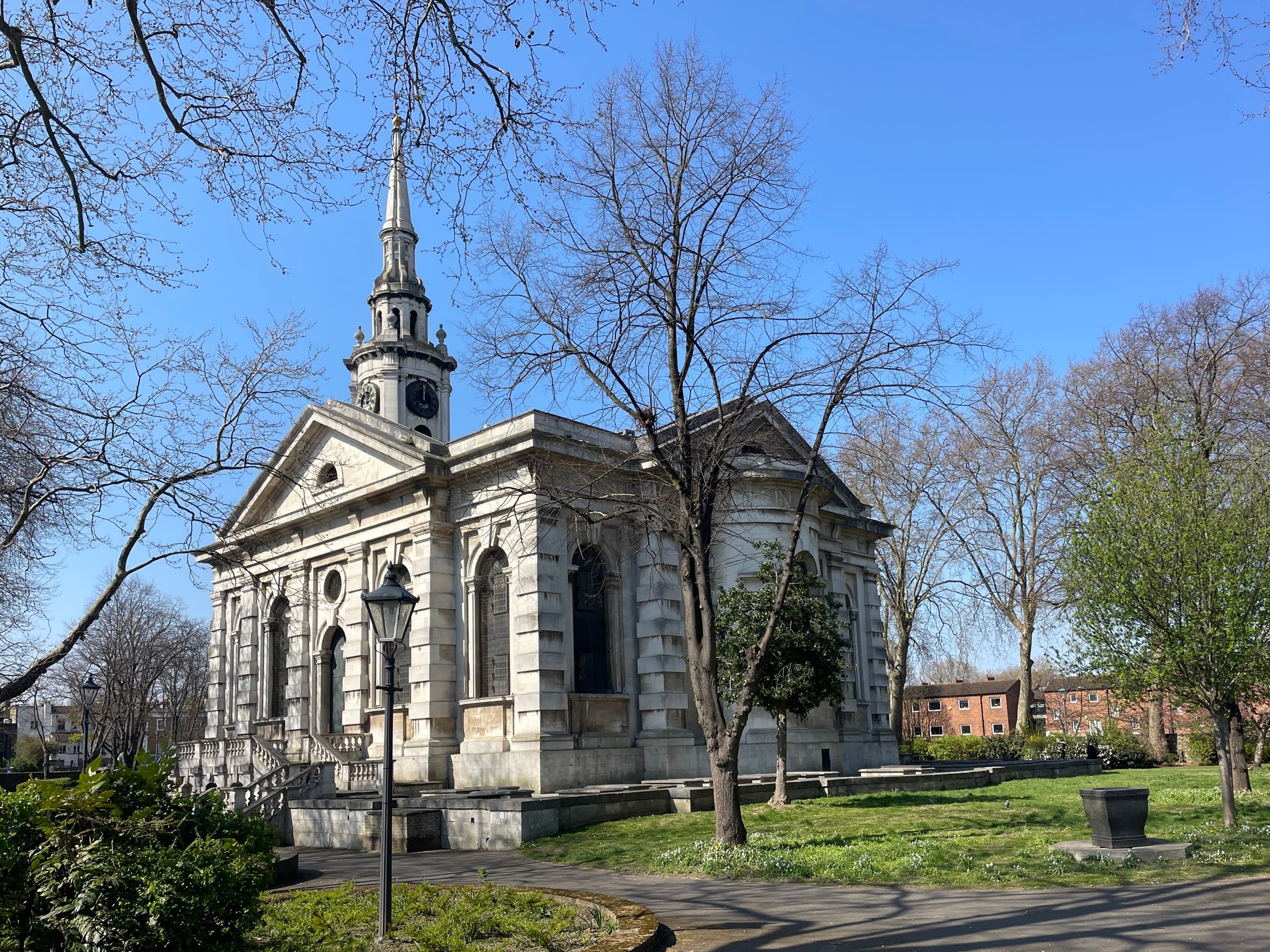 Parkside neoclassical church with lawn and trees, peaceful London park