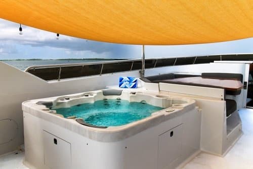 On-deck hot tub on luxury yacht under shaded canopy