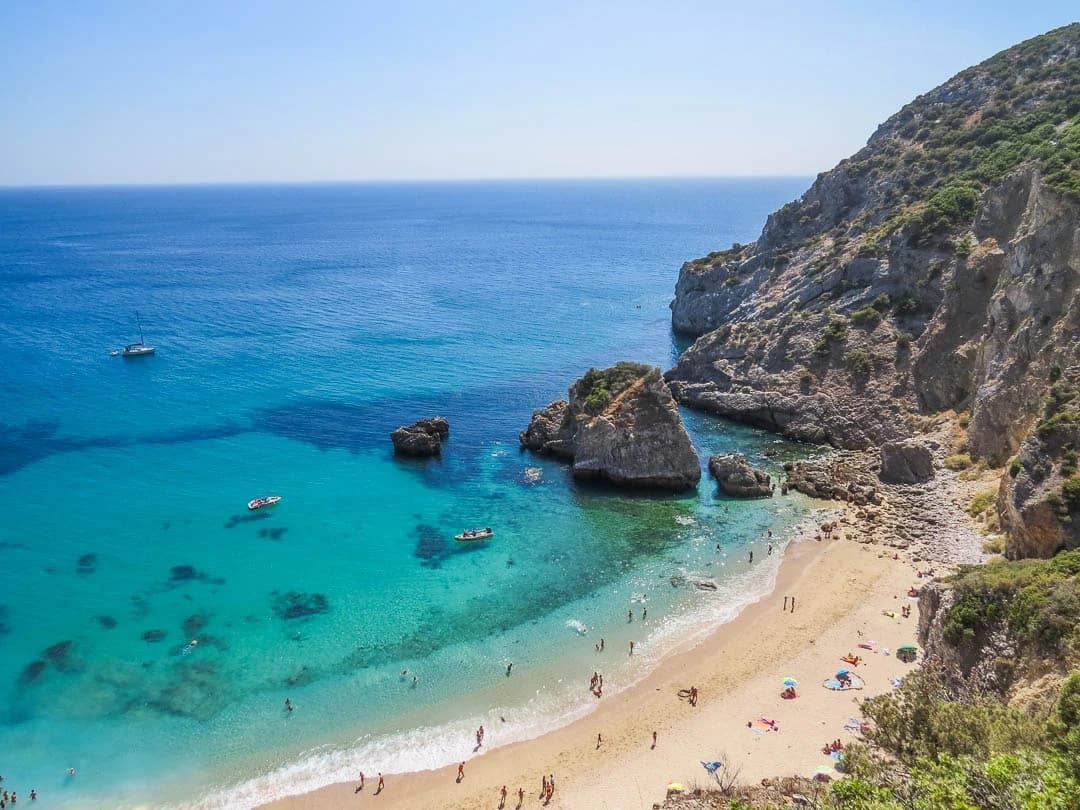 Aerial view of turquoise beach and cliffs ideal for snorkeling tours