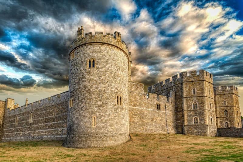 Windsor Castle fortress and ramparts under dramatic skies in Berkshire