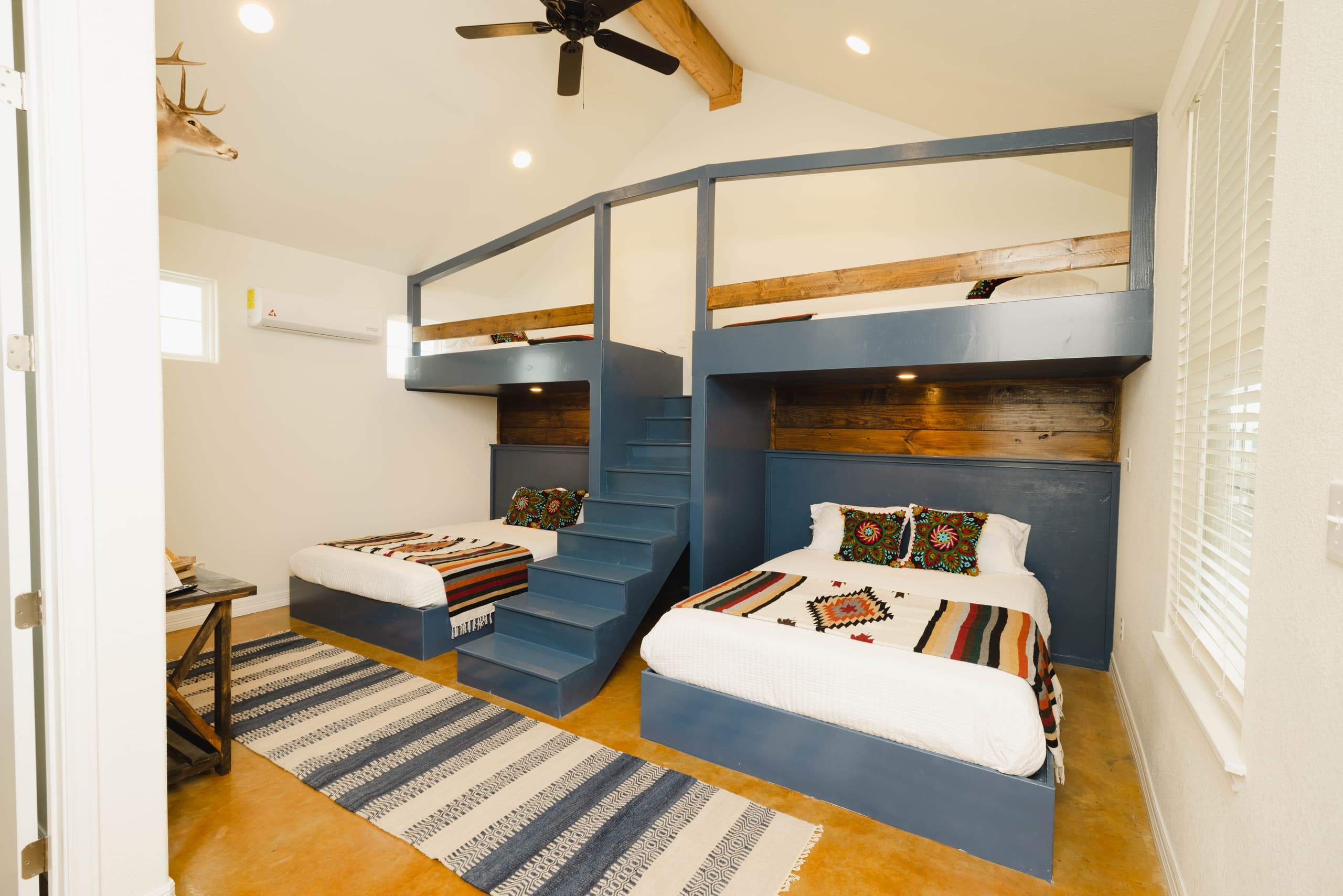 Rustic lodge bunk room with stacked beds for fishing guests