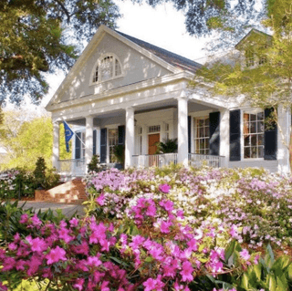 Cottage with flowering garden at historic Natchez estate grounds