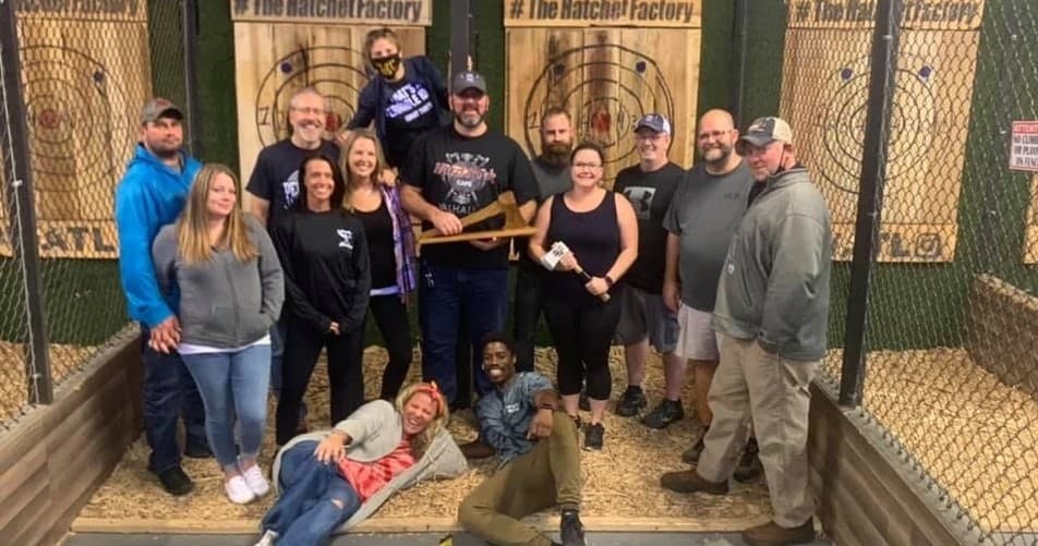 Group enjoying indoor axe throwing at target lanes facility