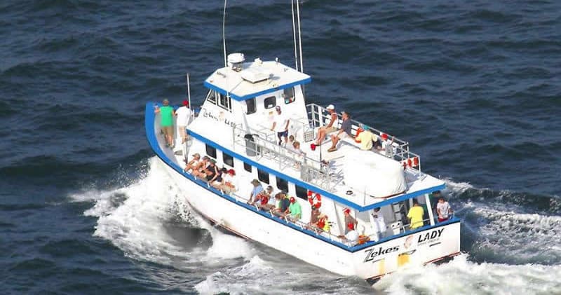 Passenger tour boat speeding offshore, ocean sightseeing cruise