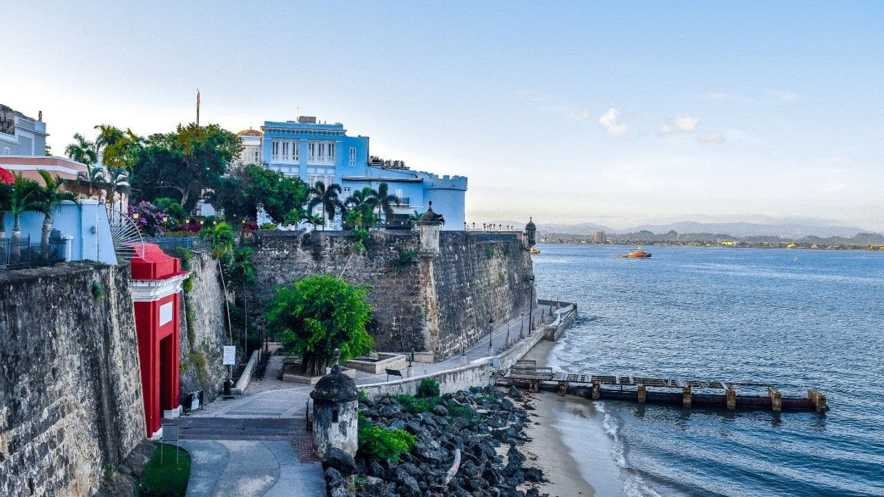 Coastal cliff walk with colorful houses and panoramic ocean vista