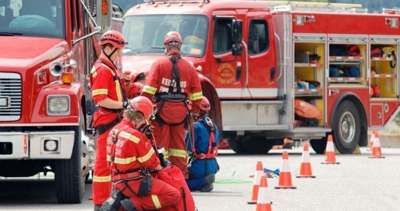 Urban fire rescue team training beside emergency fire truck on road
