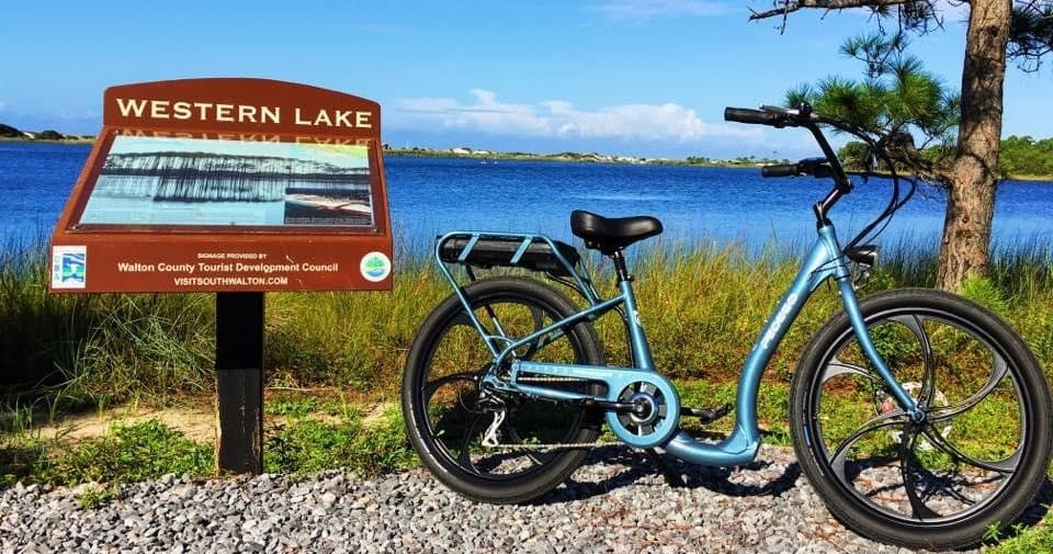 Electric cruiser bike parked by Western Lake trail scenic shore