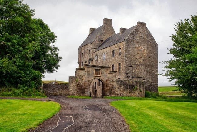 Historic stone manor house set in green parkland, Scottish castle visit