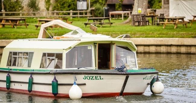 Vintage cruiser 'Jozel' moored along grassy Cotswolds riverbank