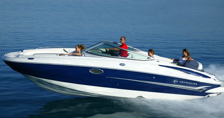 Speedboat cruising on open blue lake with passengers onboard