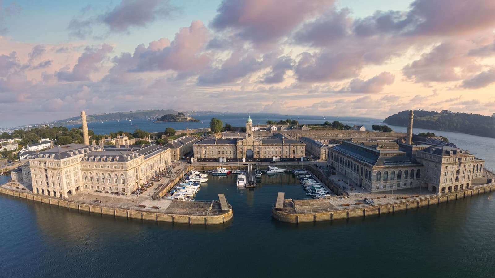 Historic waterfront fort and harbor aerial view at dusk