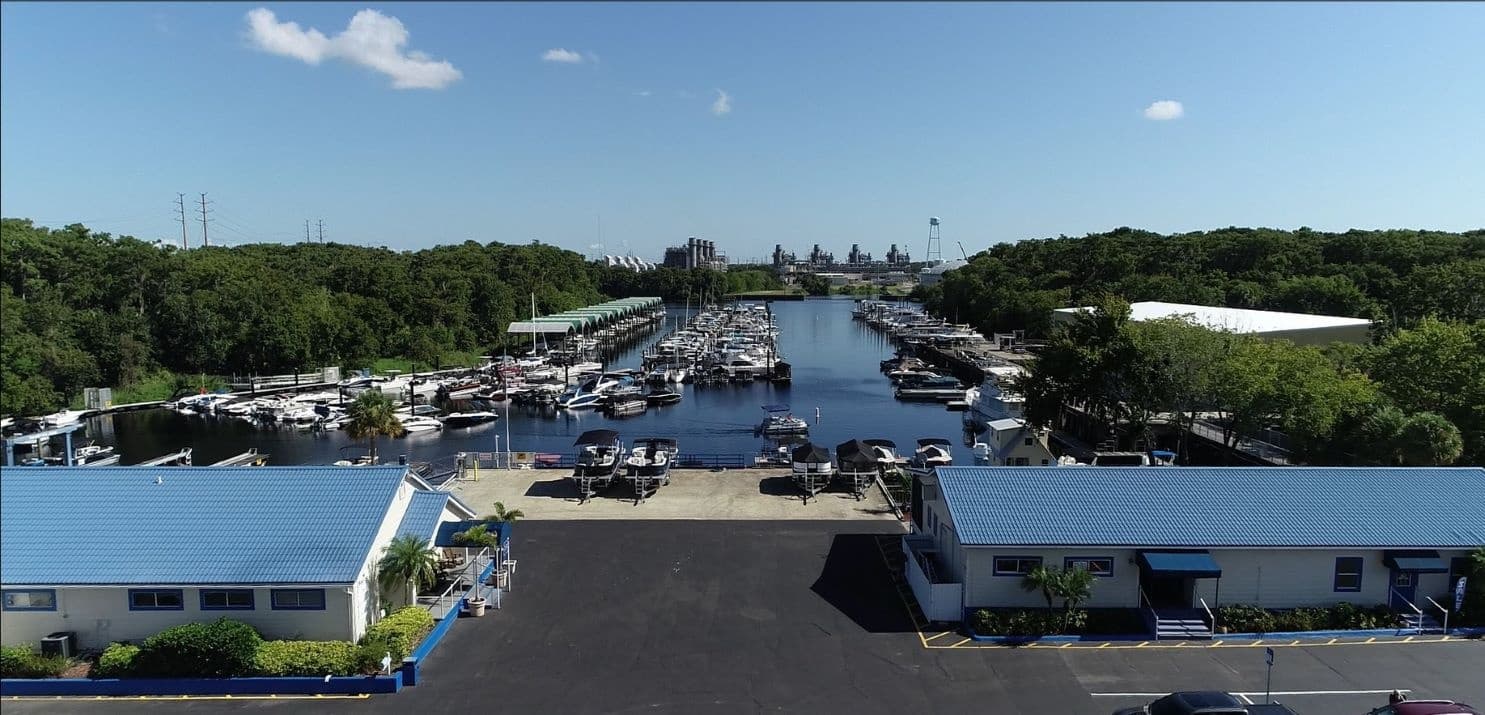 Aerial view of marina basin and boat slips framed by mangroves