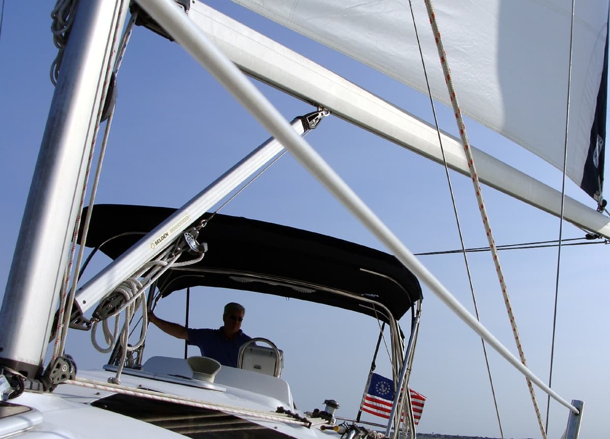 Sailboat cockpit and rigging under clear blue sky on deck