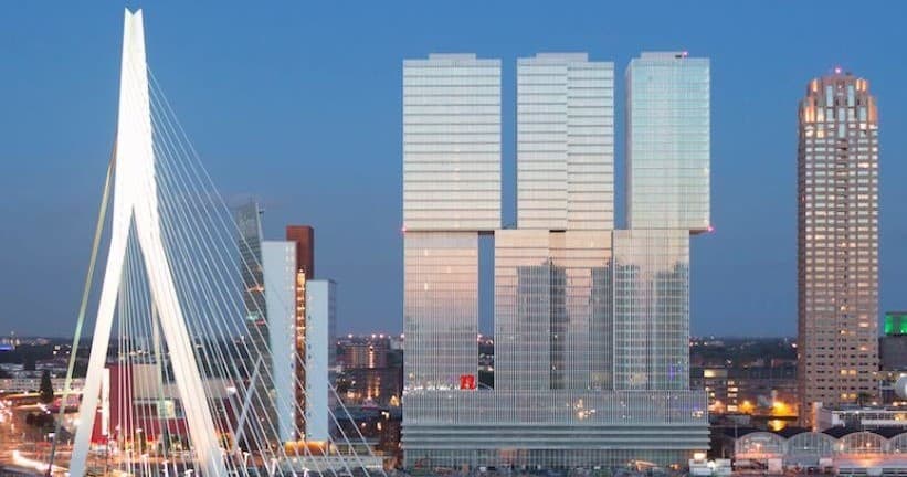 Erasmus Bridge with reflective high-rises at dusk in Rotterdam
