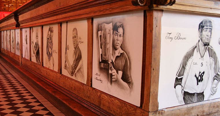 Historical sports portraits mural inside clubhouse corridor