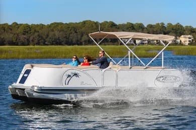 Pontoon boat cruising coastal marsh waters with passengers