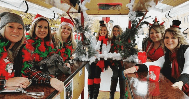 Festive pedal wagon tour in Covington, group celebrating