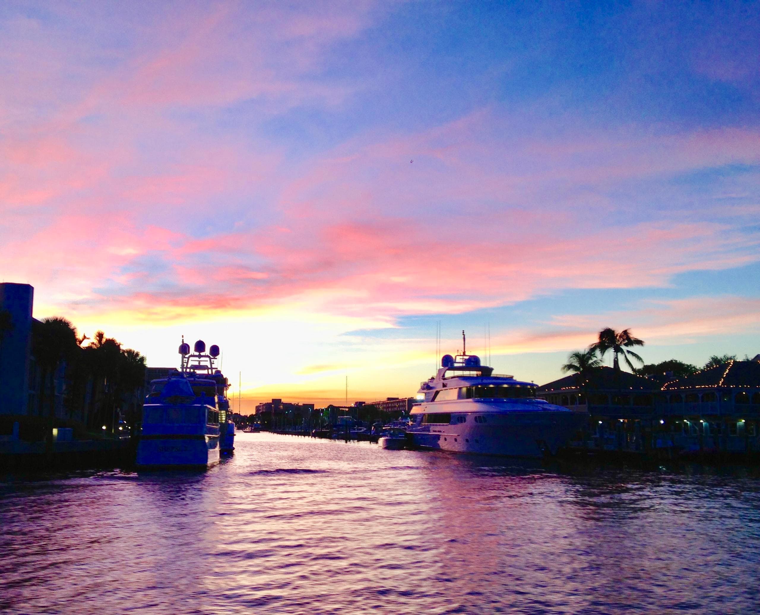 Sunset marina with yachts at waterfront, calm evening cruise