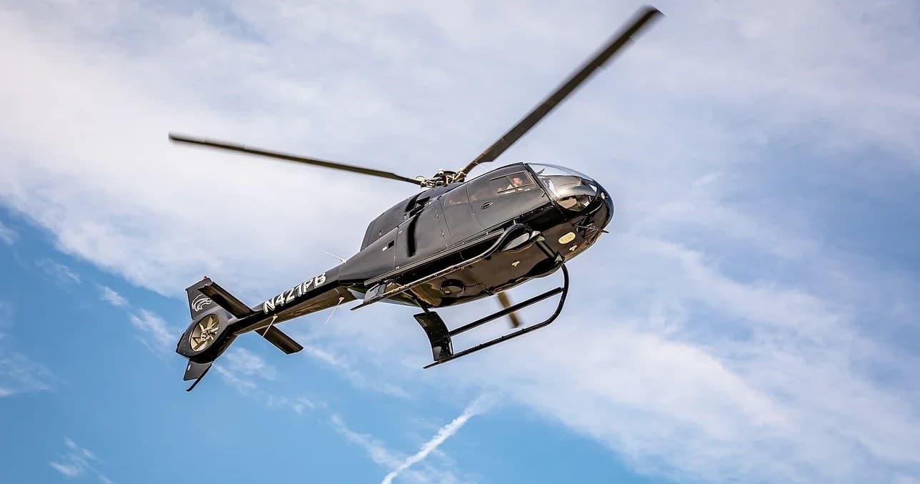 Helicopter flying over blue sky on scenic charter flight