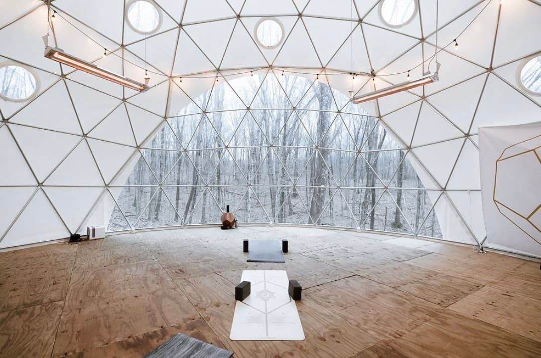 Indoor yoga dome studio with wooden floor and skylights